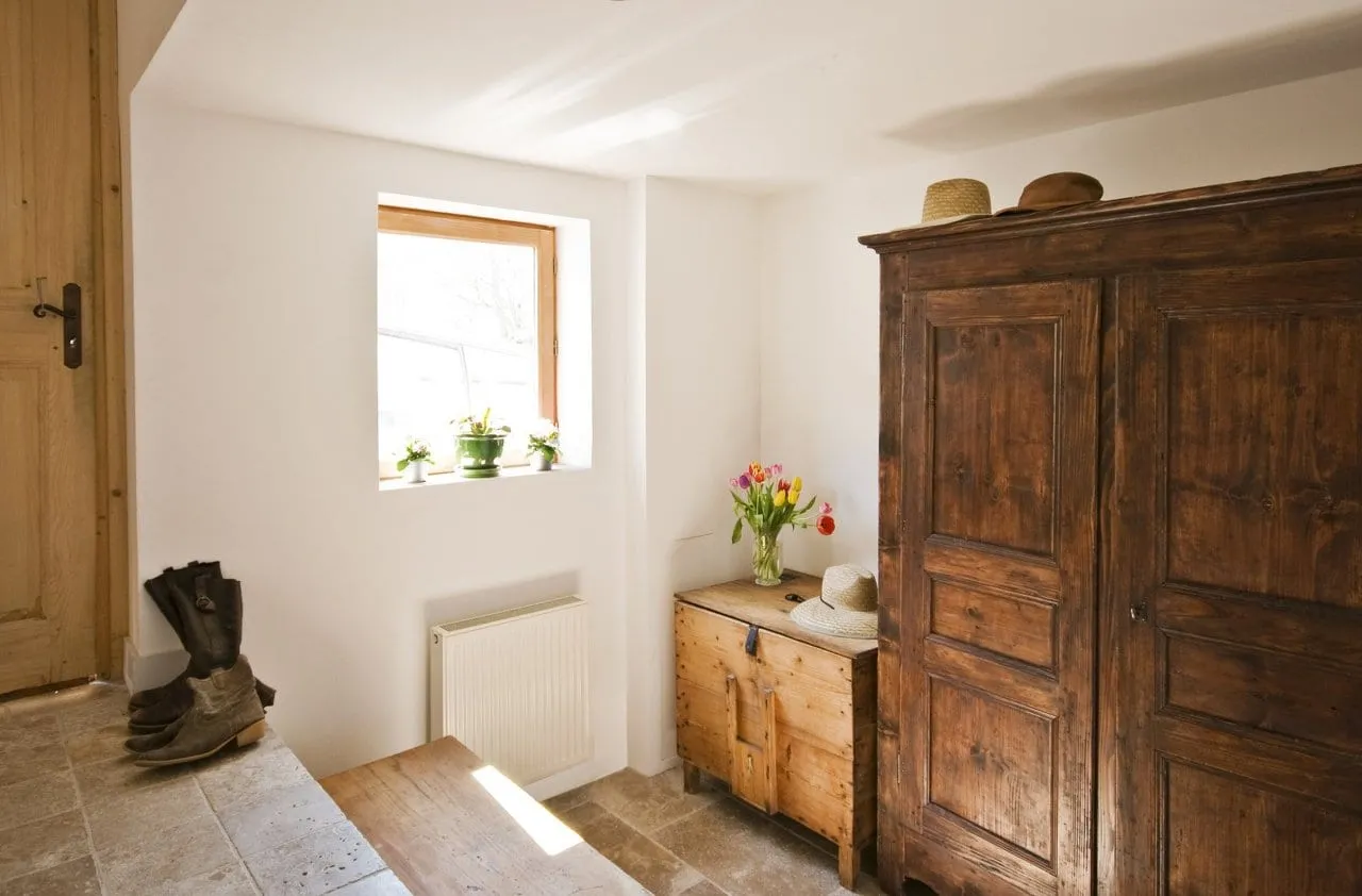 The entrance hall, with its stone walls and timber floor