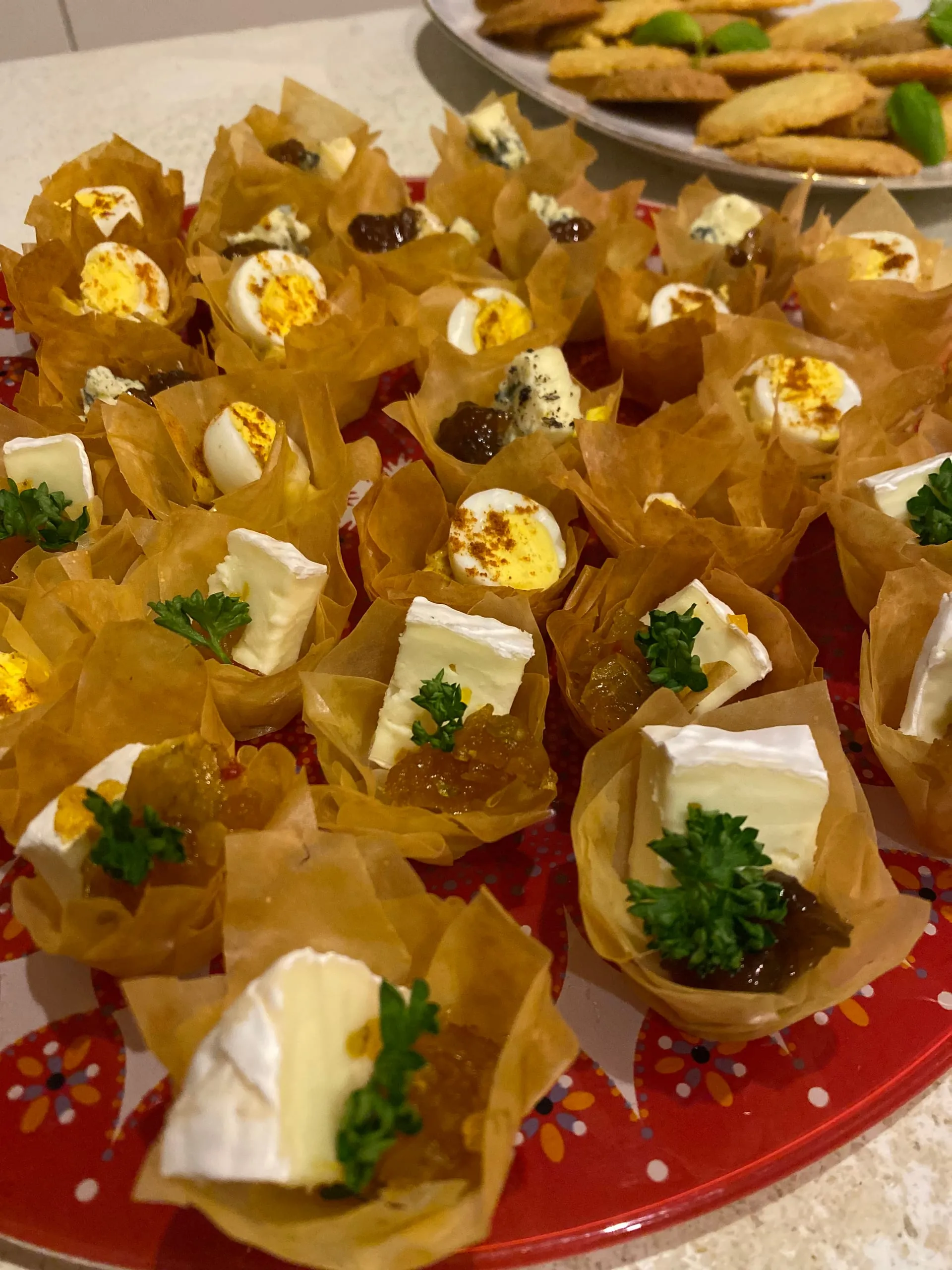 Filo pastry cups filled with brie, blue cheese, egg and chutney
