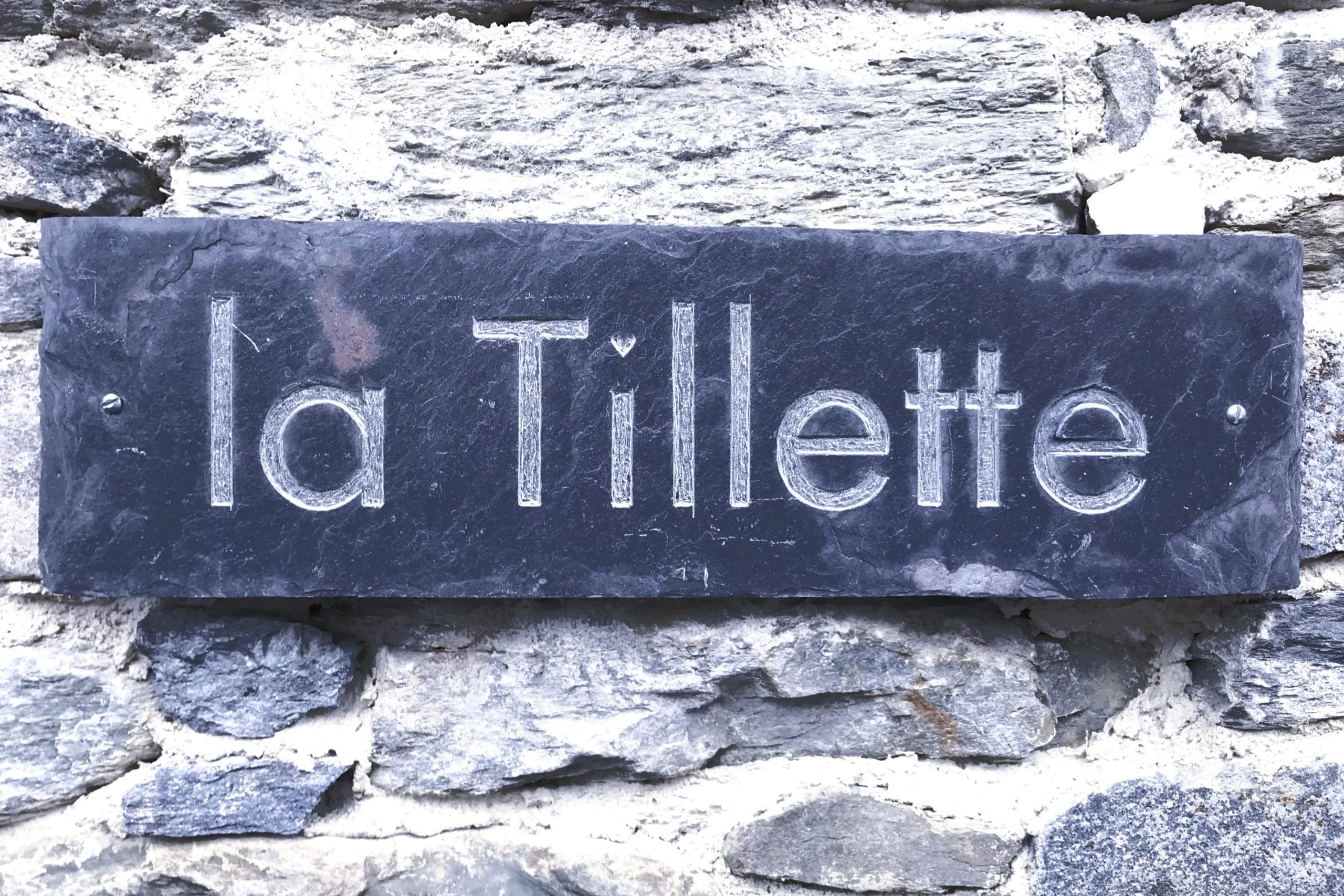 The handmade slate sign bearing the chalet’s name
