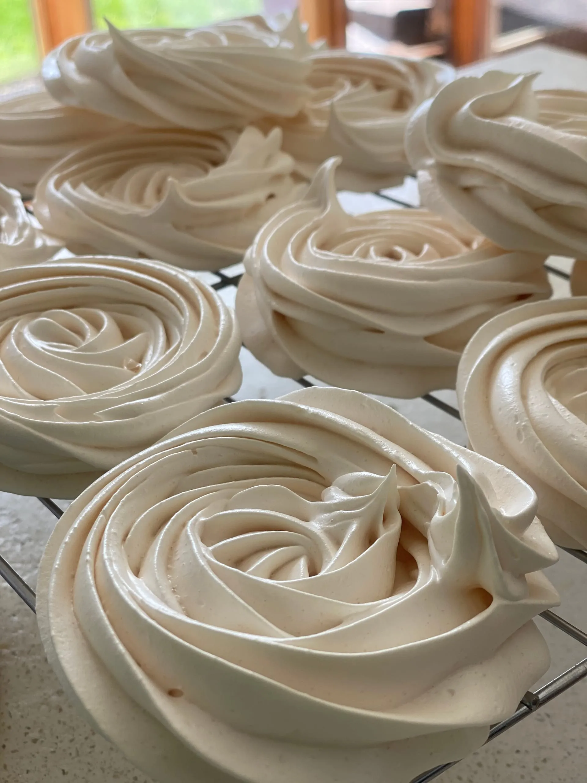 Piped meringues cooling on a wire rack