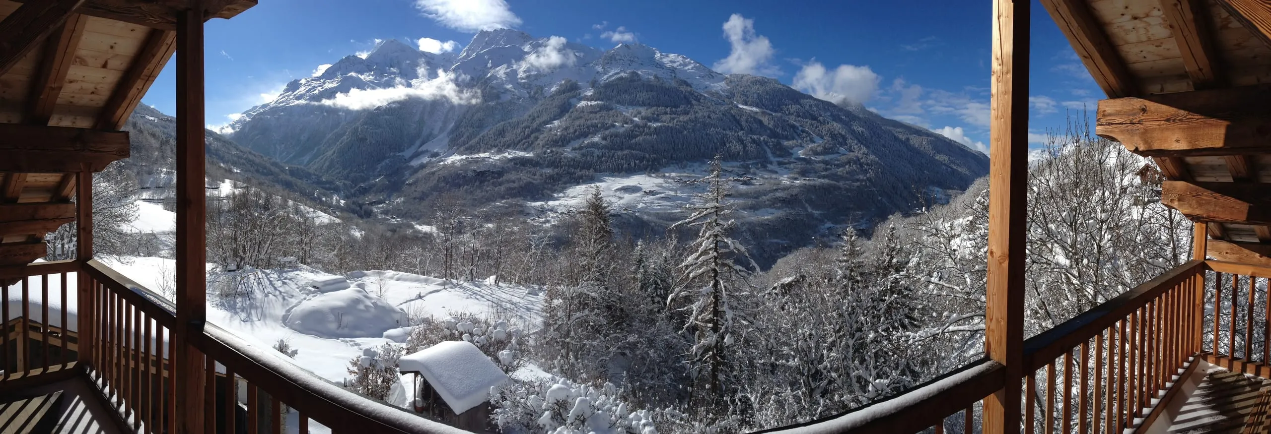 A wide panorama across the Tarentaise valley, peaks running to the horizon under a clear sky