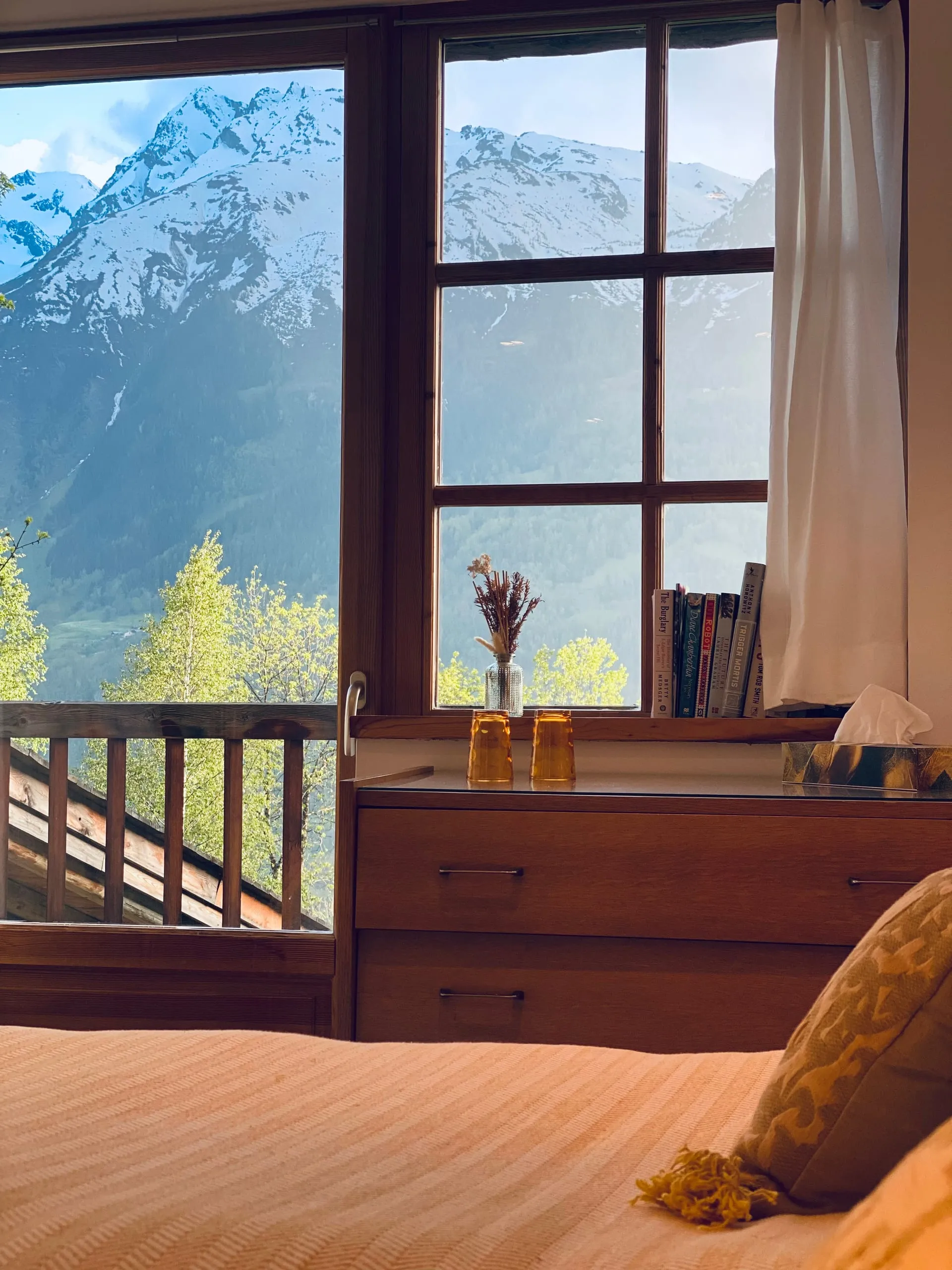 The view from the bed in bedroom two, out past the balcony to the mountains opposite