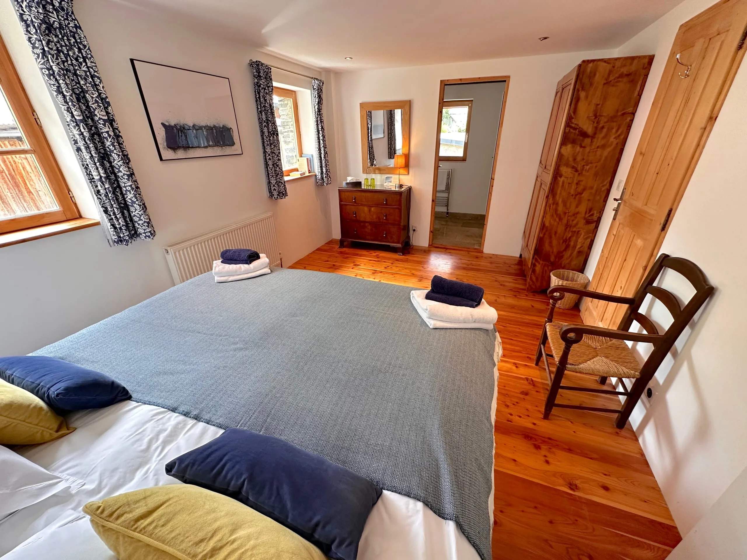 Bedroom four, the blue room, looking across the bed and through the doorway to its ensuite