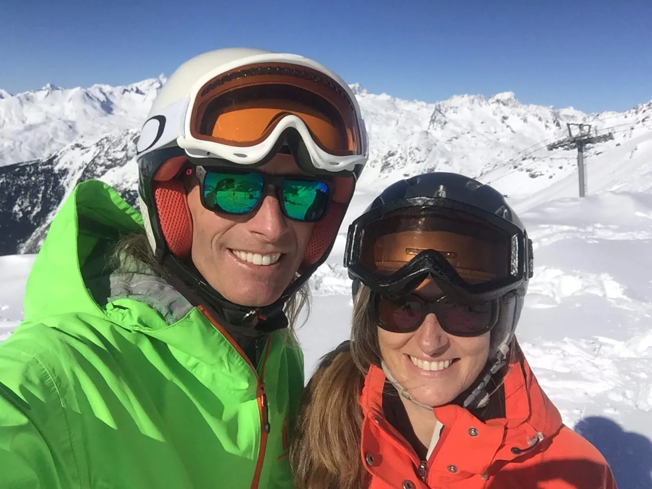 Sarah and Lloyd on the slopes above Sainte Foy, in helmets and goggles on a bright, clear day