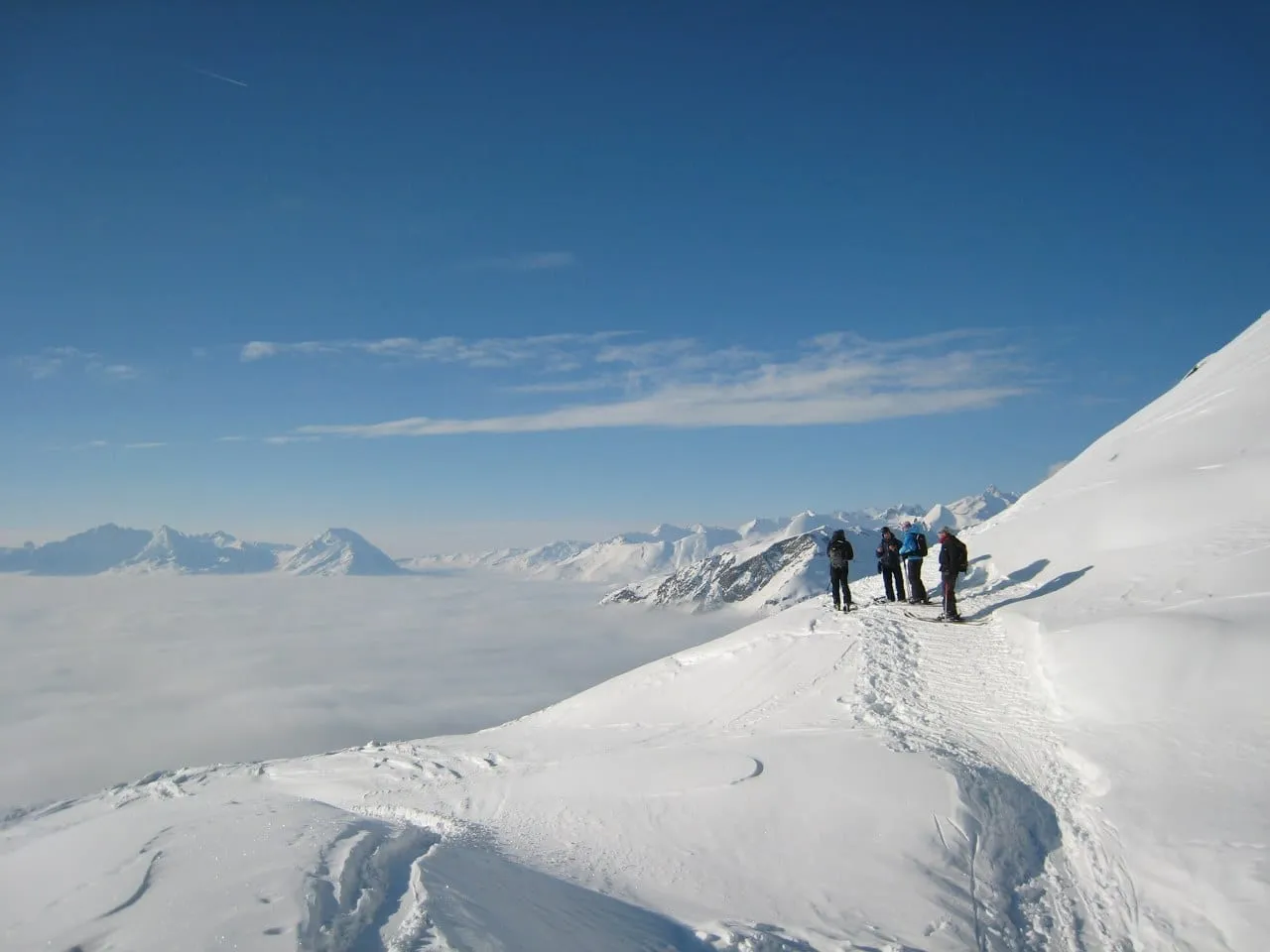 A sea of cloud filling the valley below the peaks